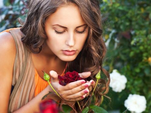 woman-smelling-rose